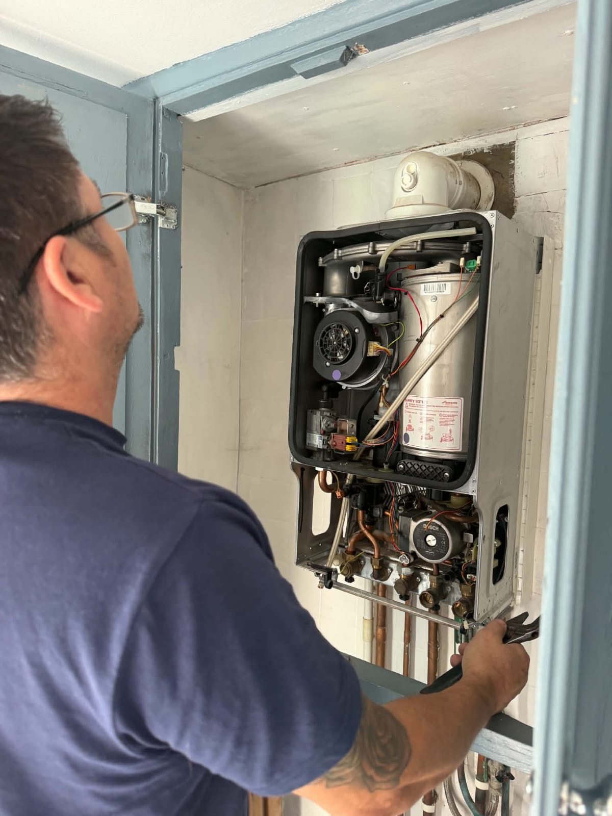 Mark working on a combi boiler
